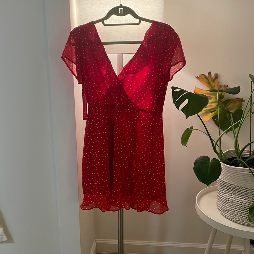 Casual flowy red dress with white dots. V-neck with partial open back with ties.